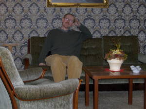 Middle-aged man sitting in sofa