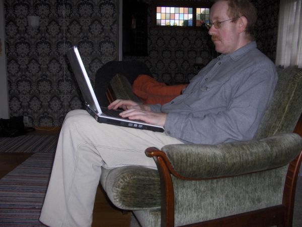 Middle-aged man with laptop computer at home