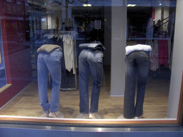 Shop window with trouser backsides