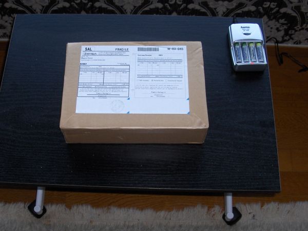 Post package and battery charger on table